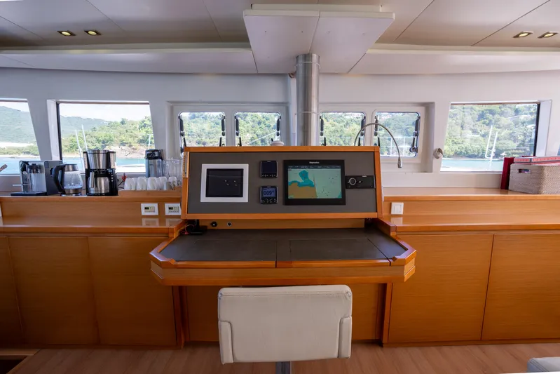  Yacht Photos Pics Interior of 2014 Lagoon 620 yacht with navigation station and panoramic windows.