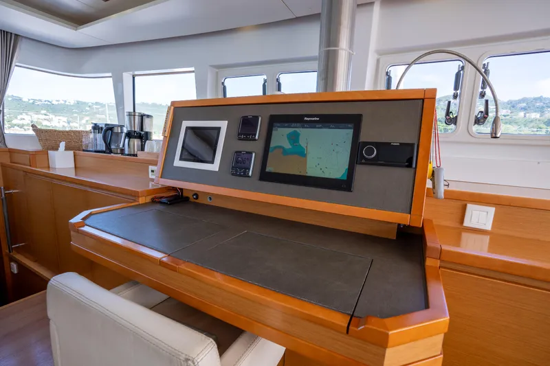  Yacht Photos Pics Navigation station on 2014 Lagoon 620 yacht with modern equipment and scenic window views.