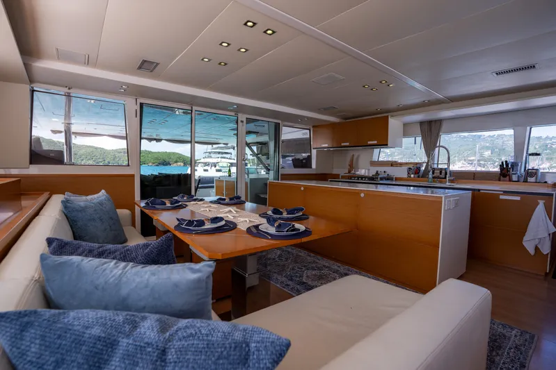  Yacht Photos Pics Luxurious interior of 2014 Lagoon 620 yacht with elegant dining area and modern kitchen.