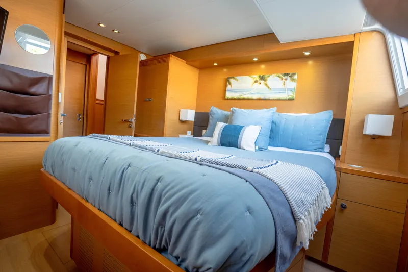 Yacht Photos Pics Luxurious bedroom interior of 2014 Lagoon 620 yacht with cozy bedding and modern decor.