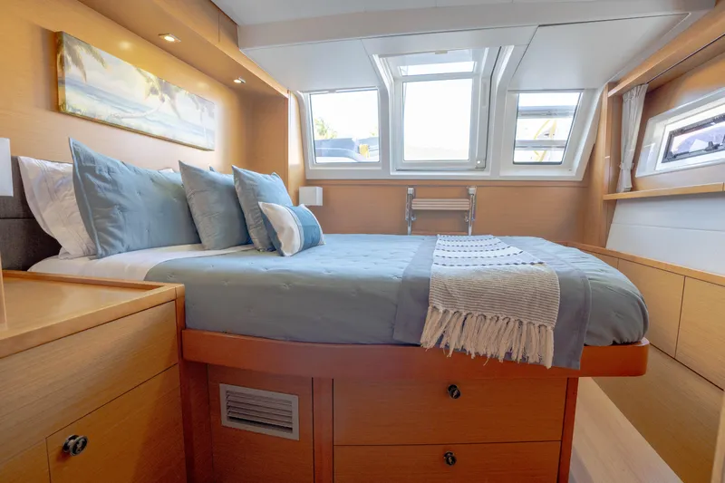  Yacht Photos Pics Luxurious cabin interior of 2014 Lagoon 620 yacht with cozy bedding and natural light.