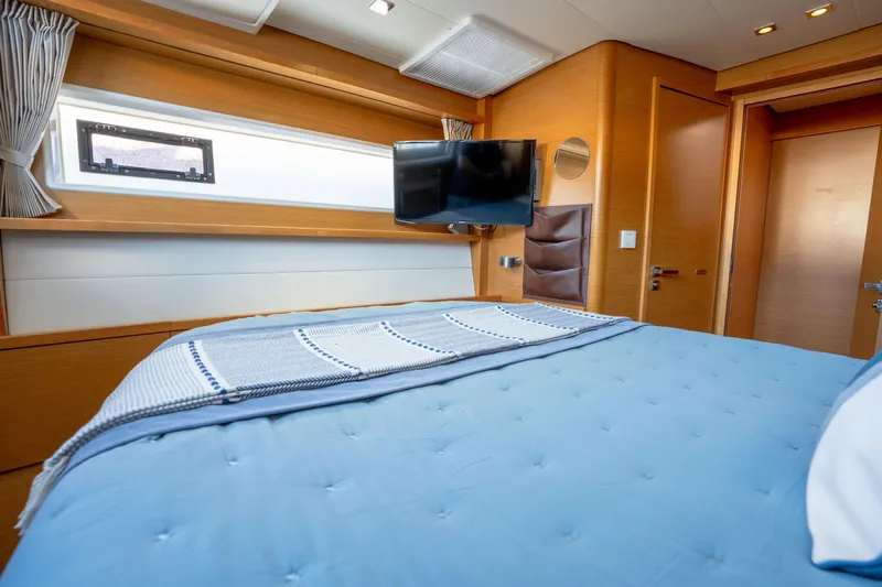  Yacht Photos Pics Luxurious cabin interior of 2014 Lagoon 620 yacht with cozy bed and TV.