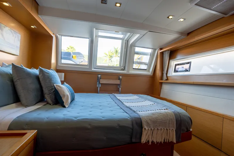 Yacht Photos Pics Luxurious cabin interior of 2014 Lagoon 620 yacht with cozy bedding and natural light.