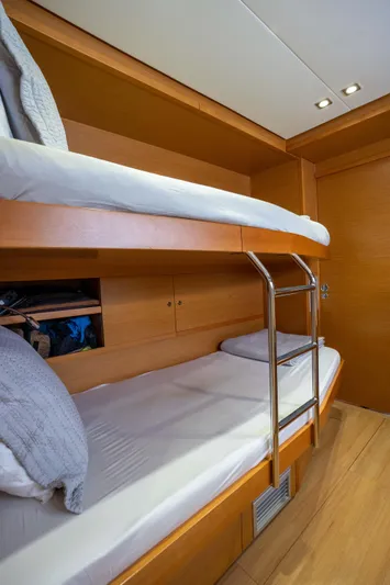  Yacht Photos Pics Bunk beds in 2014 Lagoon 620 yacht cabin with wooden interior and soft lighting.