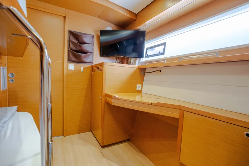  Yacht Photos Pics Luxurious interior of 2014 Lagoon 620 yacht with modern wood finish and mounted TV.