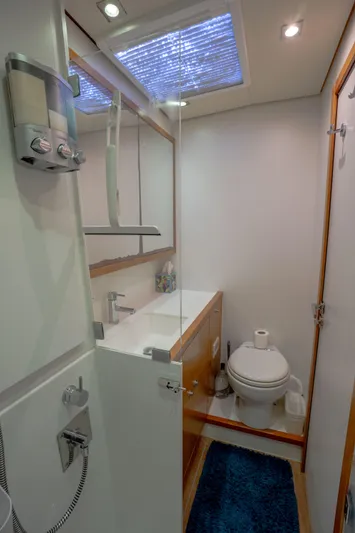  Yacht Photos Pics Bathroom interior of 2014 Lagoon 620 yacht with modern fixtures and skylight.