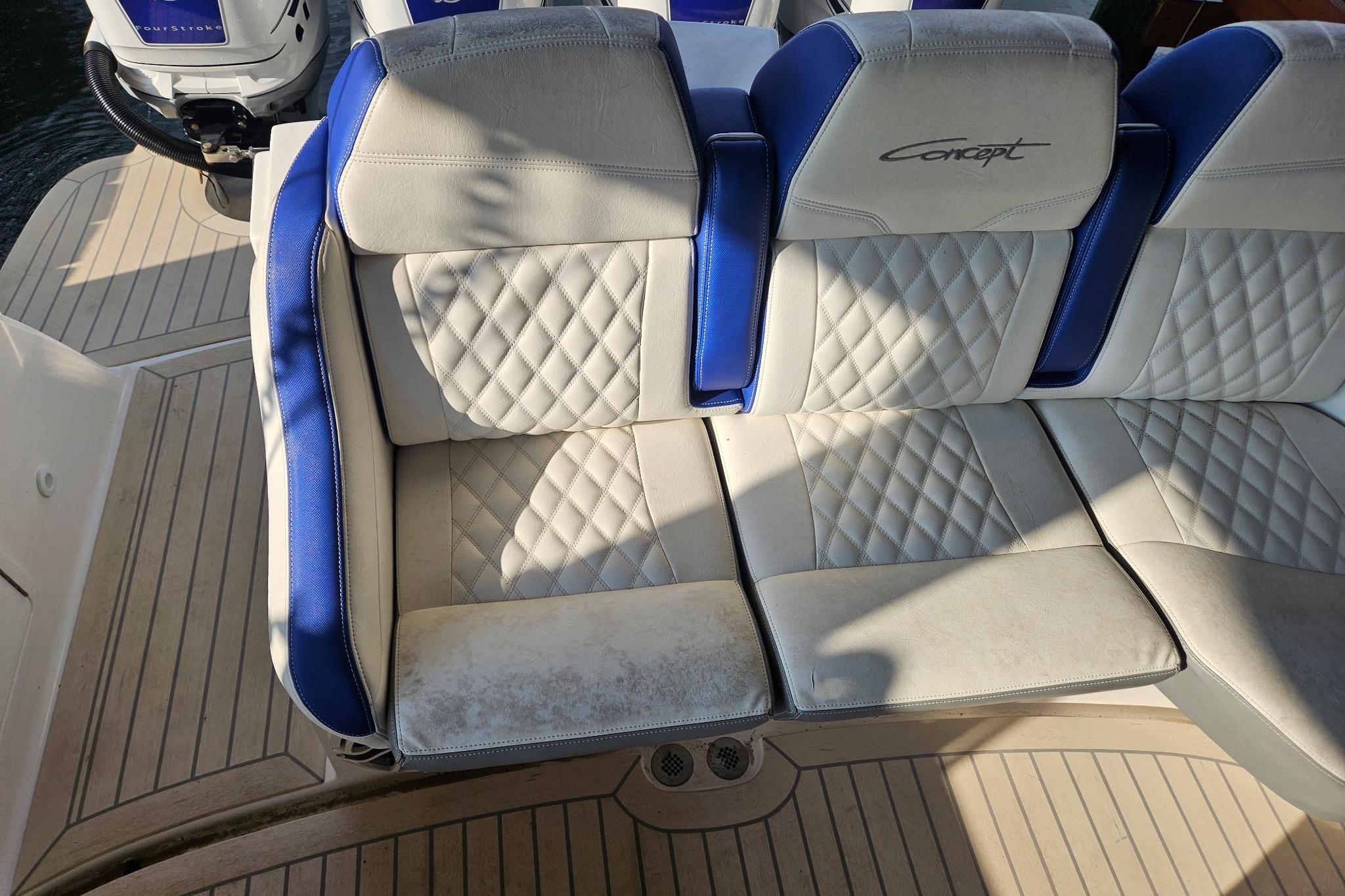 Luxurious seating on 2019 Concept 44' Cuddy Cabin boat with quilted upholstery.
