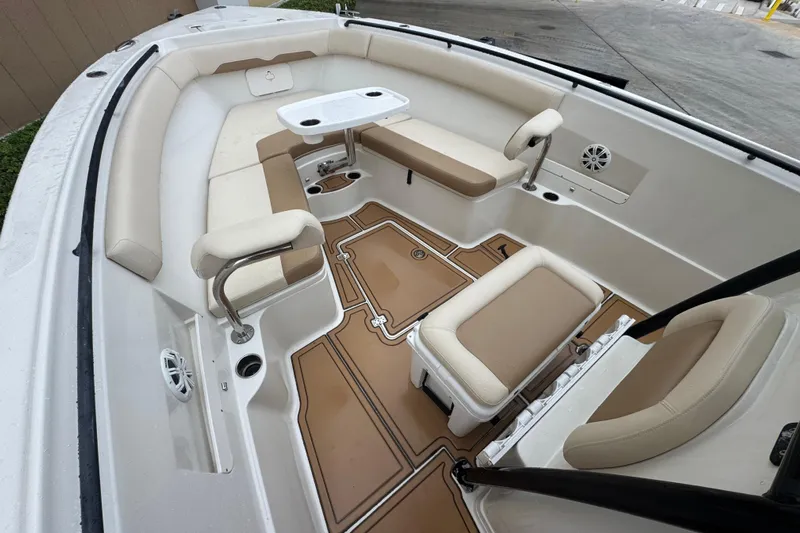  Yacht Photos Pics Interior of a 2015 Sailfish 320 CC boat with beige seating and table.