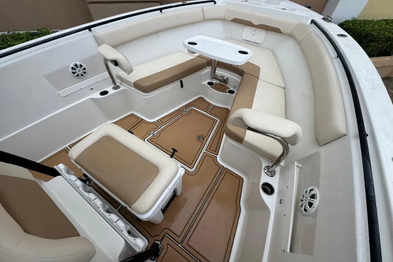  Yacht Photos Pics 2015 Sailfish 320 CC boat interior with beige seating and a small table.