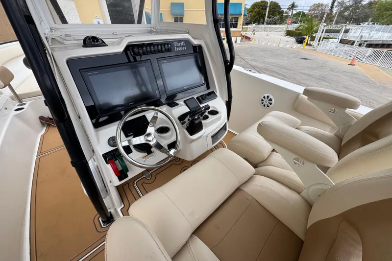  Yacht Photos Pics 2015 Sailfish 320 CC boat cockpit with dual screens and beige seating.
