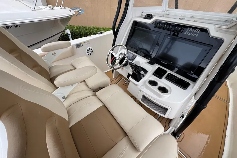  Yacht Photos Pics 2015 Sailfish 320 CC boat cockpit with dual screens and beige seating.