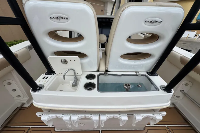  Yacht Photos Pics 2015 Sailfish 320 CC boat interior with sink, cup holders, and storage compartments.