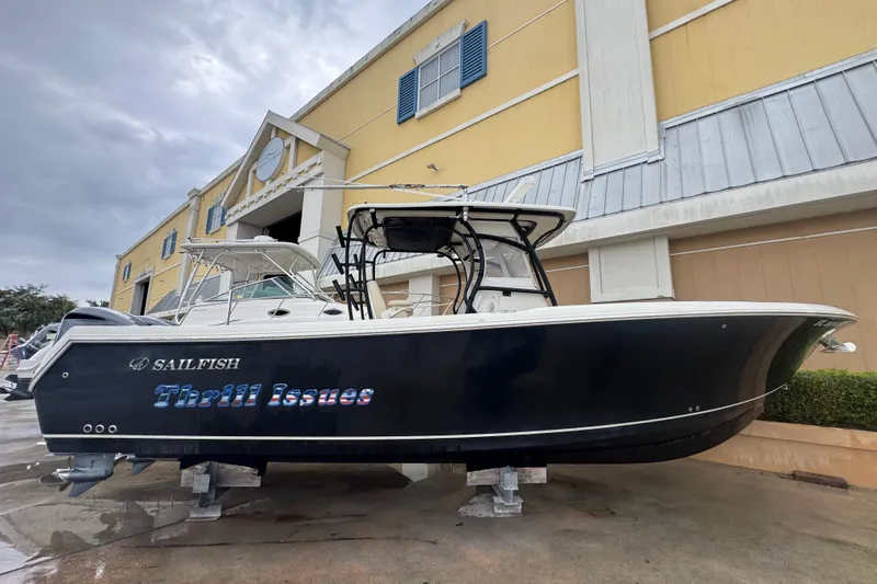  Yacht Photos Pics 2015 Sailfish 320 CC boat named "Thrill Issues" on display outside a building.