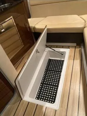  Yacht Photos Pics 2013 Regal 35 Sport Coupe interior with open storage compartment on wooden floor.
