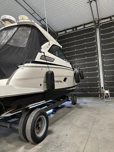  Yacht Photos Pics 2013 Regal 35 Sport Coupe boat in storage facility on trailer.