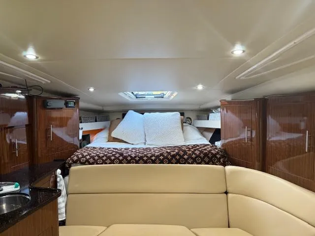  Yacht Photos Pics Luxurious interior of 2013 Regal 35 Sport Coupe with cozy bed and elegant wood cabinetry.