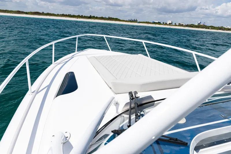  Yacht Photos Pics 2018 Intrepid 438 Evolution yacht cruising on open water near coastline.