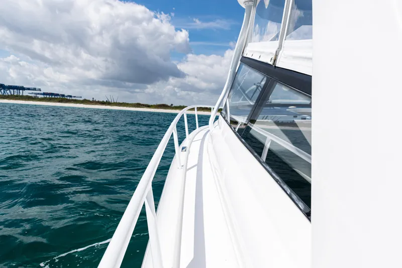  Yacht Photos Pics 2018 Intrepid 438 Evolution yacht cruising on open water under a cloudy sky.