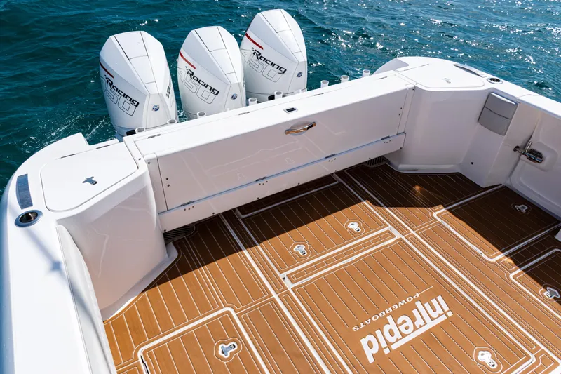  Yacht Photos Pics 2018 Intrepid 438 Evolution boat deck with triple outboard engines on the ocean.