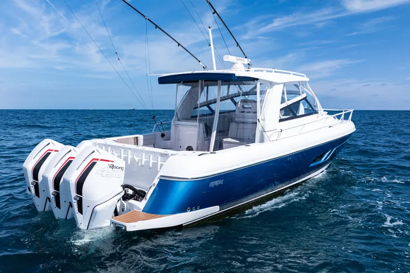  Yacht Photos Pics 2018 Intrepid 438 Evolution boat cruising on open sea with clear blue skies.