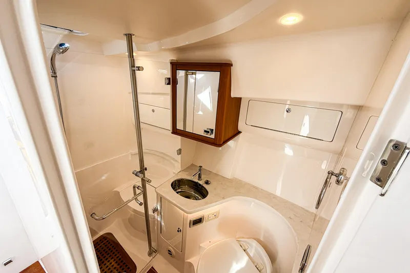  Yacht Photos Pics Luxurious bathroom interior of 2018 Intrepid 438 Evolution yacht, featuring modern fixtures and elegant design.