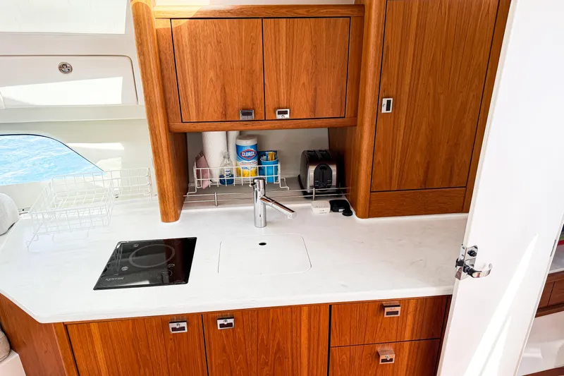  Yacht Photos Pics Modern kitchen area in 2018 Intrepid 438 Evolution yacht with wooden cabinets and sleek appliances.