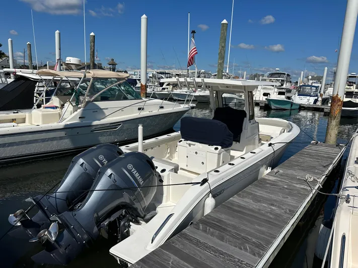  Yacht Photos Pics 2024 Pursuit S 268 boat docked with twin Yamaha engines, marina background.