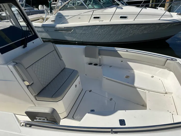  Yacht Photos Pics 2024 Pursuit S 268 boat interior with seating and storage compartments.