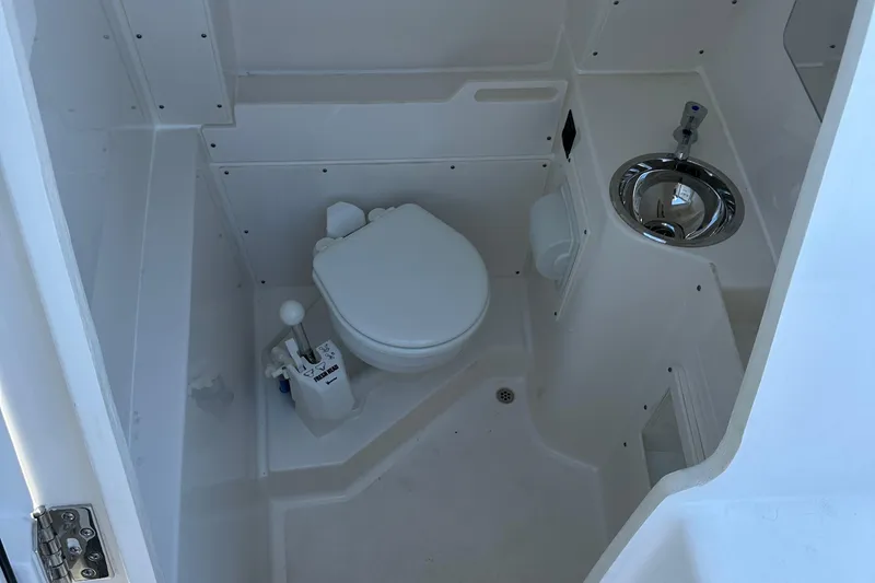  Yacht Photos Pics 2024 Pursuit S 268 boat interior bathroom with toilet and sink.