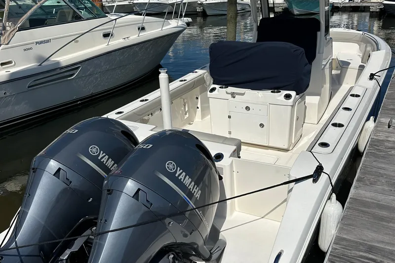  Yacht Photos Pics 2024 Pursuit S 268 boat with twin Yamaha engines docked at a marina.