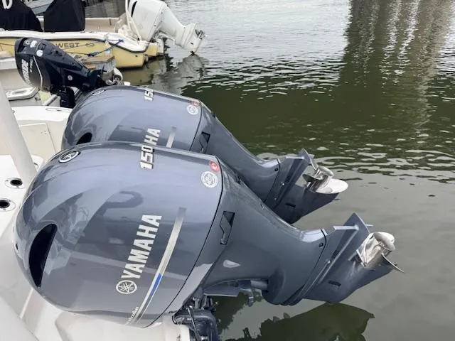  Yacht Photos Pics Twin Yamaha 150 outboard motors on a 2024 Pursuit S 268 boat, docked on calm water.