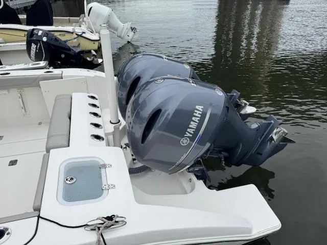  Yacht Photos Pics 2024 Pursuit S 268 boat with dual Yamaha outboard motors on calm water.