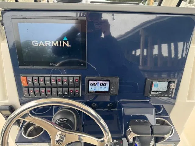  Yacht Photos Pics 2024 Pursuit S 268 boat dashboard with Garmin navigation system and control panel.