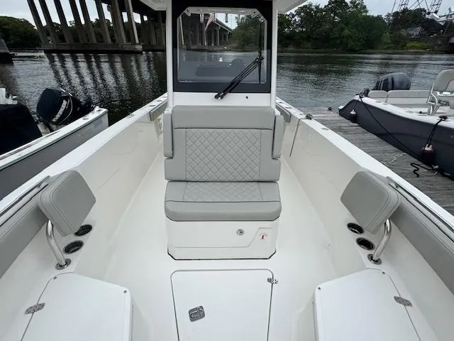  Yacht Photos Pics 2024 Pursuit S 268 boat interior with seating, docked by a river.