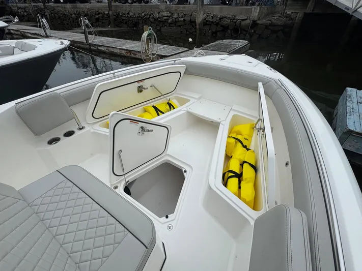  Yacht Photos Pics 2024 Pursuit S 268 boat with open storage compartments and visible life jackets.