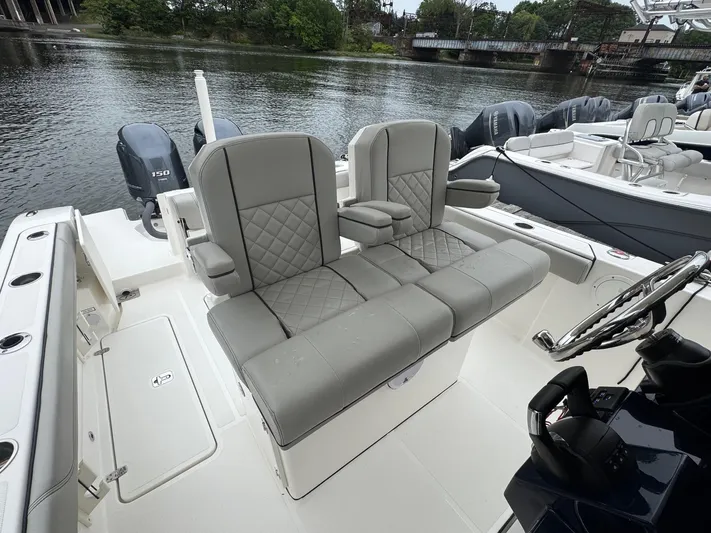  Yacht Photos Pics 2024 Pursuit S 268 boat interior with gray seating and water view.