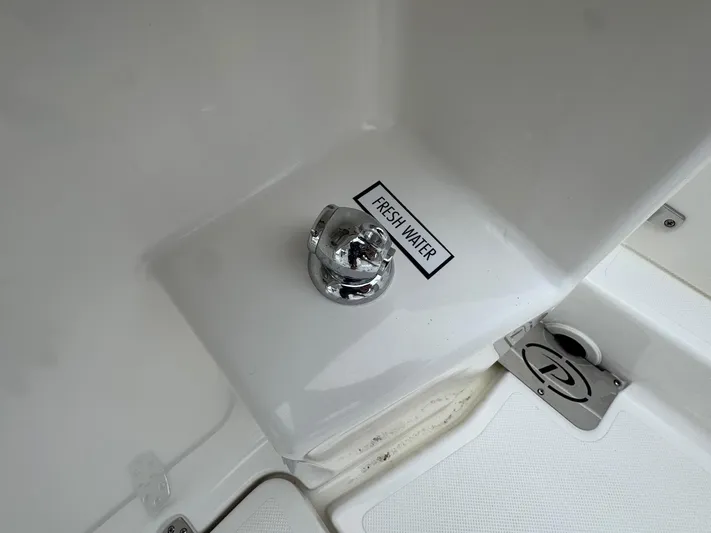  Yacht Photos Pics 2024 Pursuit S 268 boat fresh water access point with chrome fixture.
