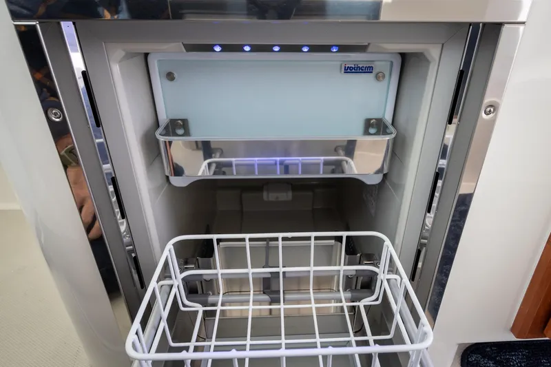 Naut On Call Yacht Photos Pics Ice maker inside a 2016 Back Cove 34 yacht, featuring a sleek stainless steel design.