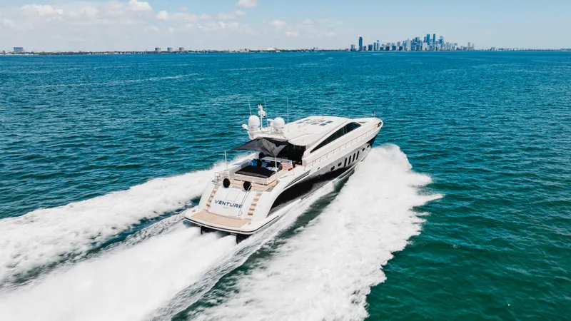 Venture Yacht Photos Pics Luxury Leopard yacht cruising on open sea, city skyline in background, 2007 model.