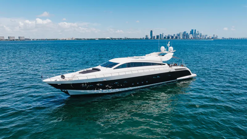 Venture Yacht Photos Pics Luxurious 2007 Leopard yacht cruising on blue ocean with city skyline in background.