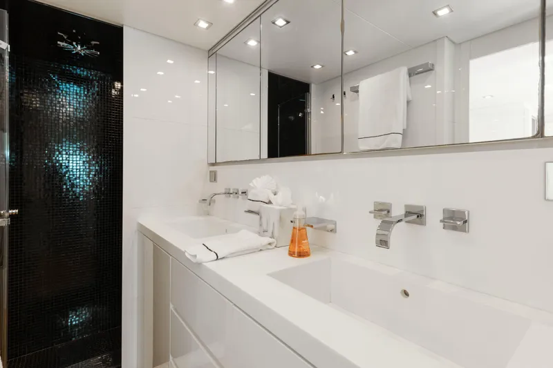 Venture Yacht Photos Pics Luxurious yacht bathroom with sleek design, modern fixtures, and elegant black tile accents.