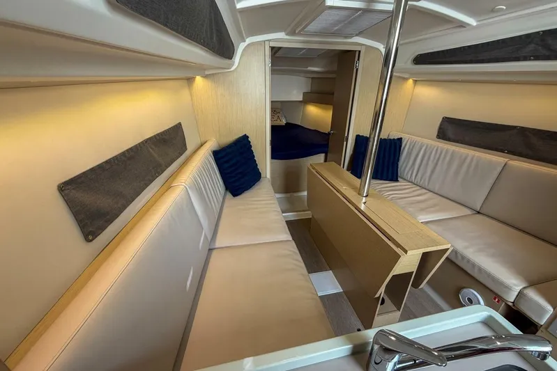 Coastal Distancing Yacht Photos Pics Interior of 2021 Beneteau Oceanis 30.1 yacht, featuring cozy seating and modern design.
