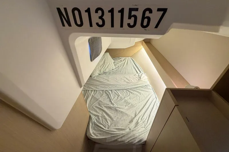 Coastal Distancing Yacht Photos Pics Cozy cabin interior of 2021 Beneteau Oceanis 30.1 sailboat with bed and storage.