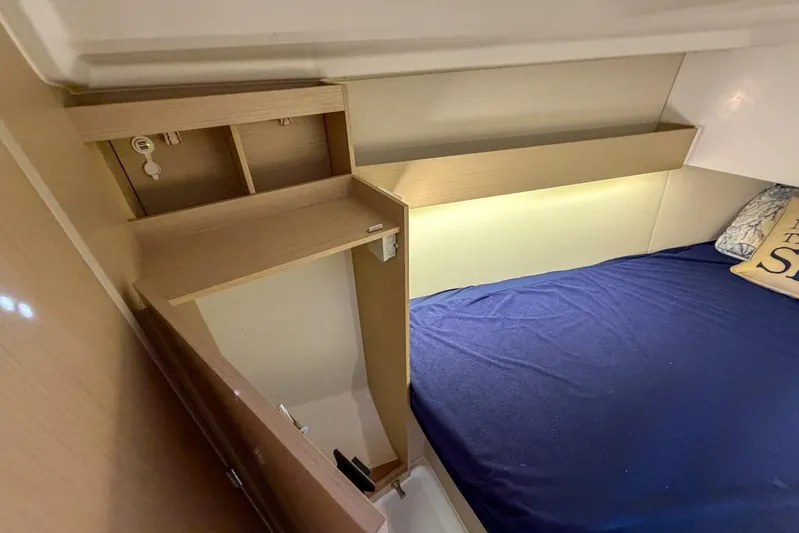 Coastal Distancing Yacht Photos Pics Interior cabin of 2021 Beneteau Oceanis 30.1 yacht with cozy bed and wooden storage.