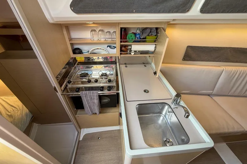 Coastal Distancing Yacht Photos Pics Interior of 2021 Beneteau Oceanis 30.1 yacht kitchen with stove and sink.