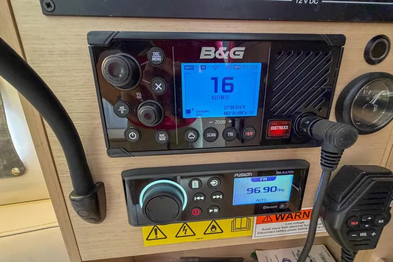 Coastal Distancing Yacht Photos Pics Control panel of a 2021 Beneteau Oceanis 30.1 sailboat with radio and navigation systems.