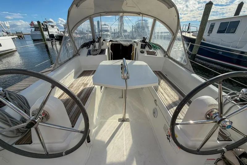 Coastal Distancing Yacht Photos Pics 2021 Beneteau Oceanis 30.1 sailboat cockpit with dual steering wheels and marina view.