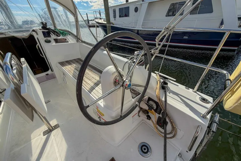 Coastal Distancing Yacht Photos Pics Cockpit of 2021 Beneteau Oceanis 30.1 sailboat with steering wheel and seating.