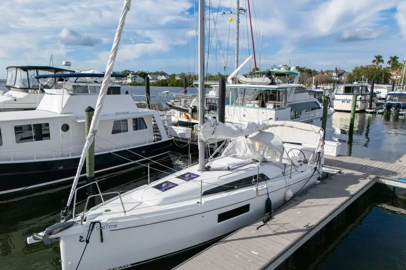 Coastal Distancing Yacht Photos Pics 2021 Beneteau Oceanis 30.1 sailboat docked at a marina, surrounded by other boats.