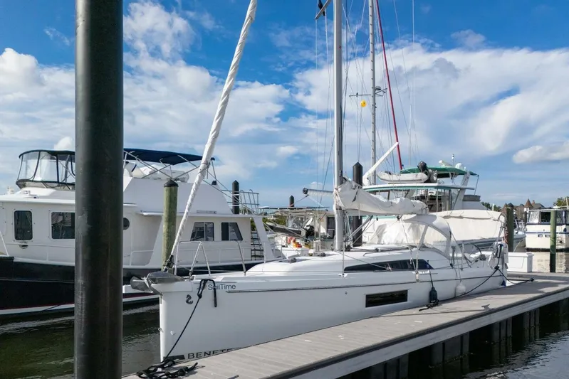 Coastal Distancing Yacht Photos Pics 2021 Beneteau Oceanis 30.1 sailboat docked at marina under blue sky.